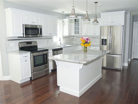 kitchen with white cabinets and easy care stainless steel refrigerator|white kitchen with stainless steel appliances.